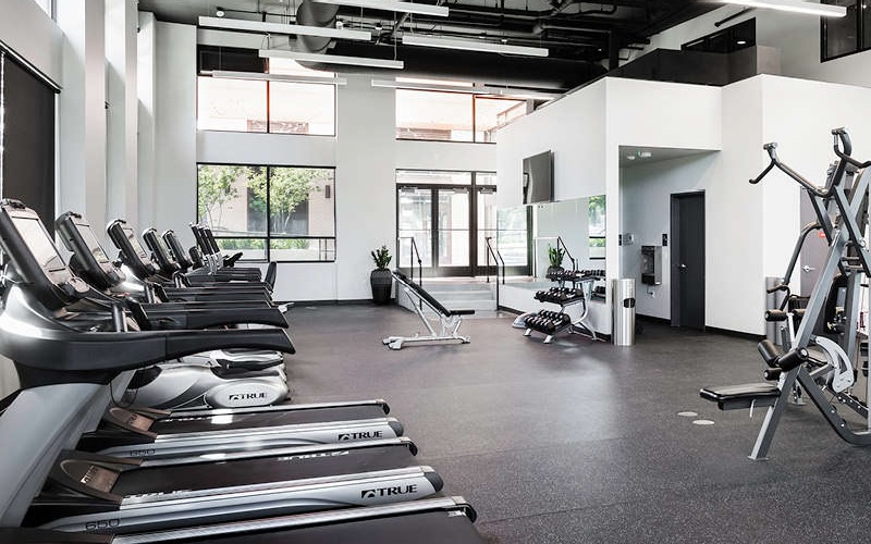spacious fitness center with ample lighting throughout